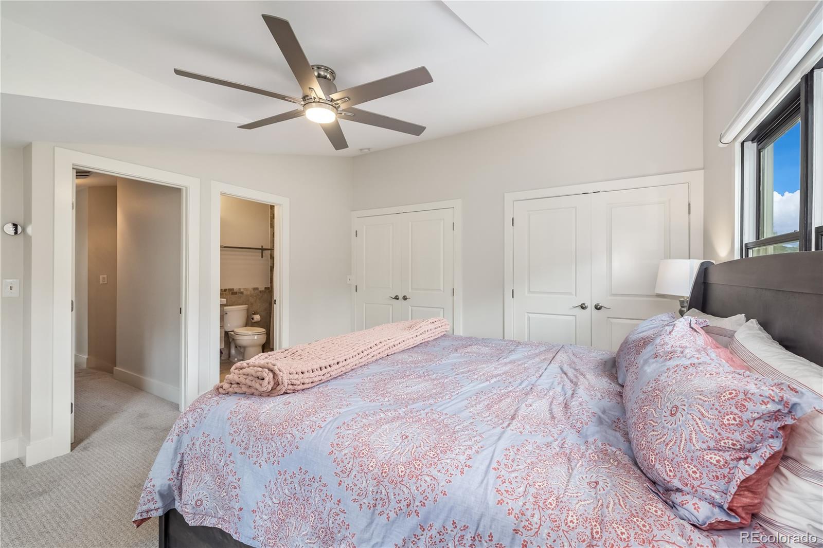 196 Wellington Road Breckenridge, CO 80424 - Photo 19 of 45 a bedroom with a bed and a ceiling fan