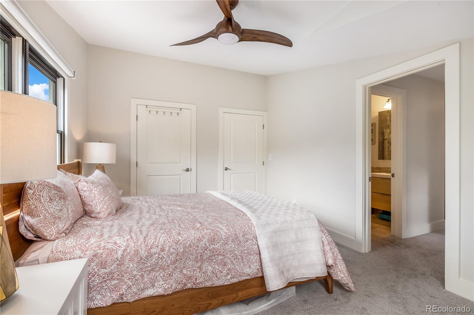 196 Wellington Road Breckenridge, CO 80424 - Photo 25 of 45 a bedroom with a bed and a chandelier