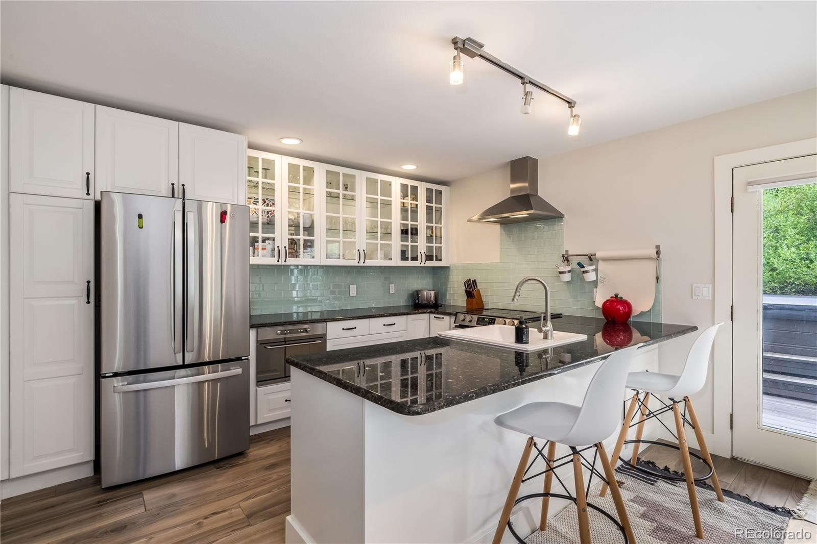 196 Wellington Road Breckenridge, CO 80424 - Photo 7 of 45 a kitchen that has a sink cabinets and stainless steel appliances