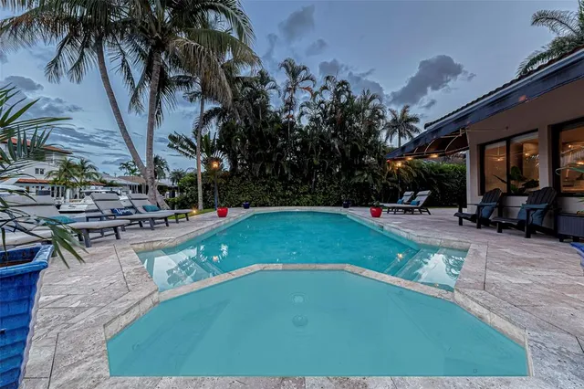 a living room with furniture a flat screen tv and a large window