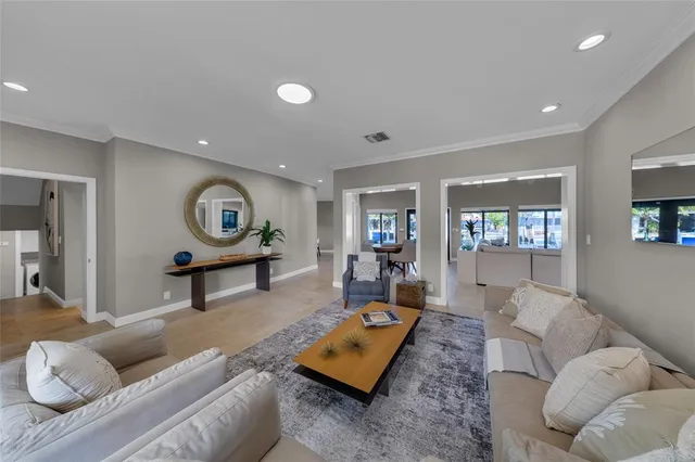 a living room with furniture a window and flat screen tv