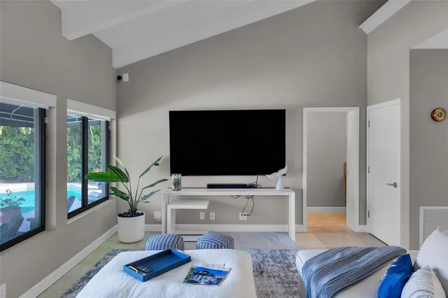 a spacious bedroom with a bed and large window