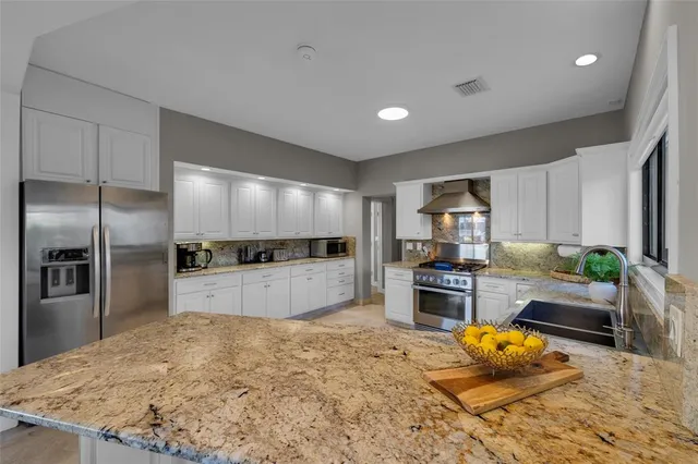 a view of a patio with a table and chairs