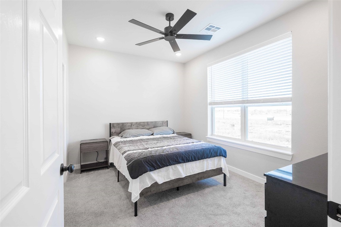 2101 Reinke Road, Unit 2105 Waller, TX 77484 - Photo 6 of 23 a bed sitting in a bedroom next to a window