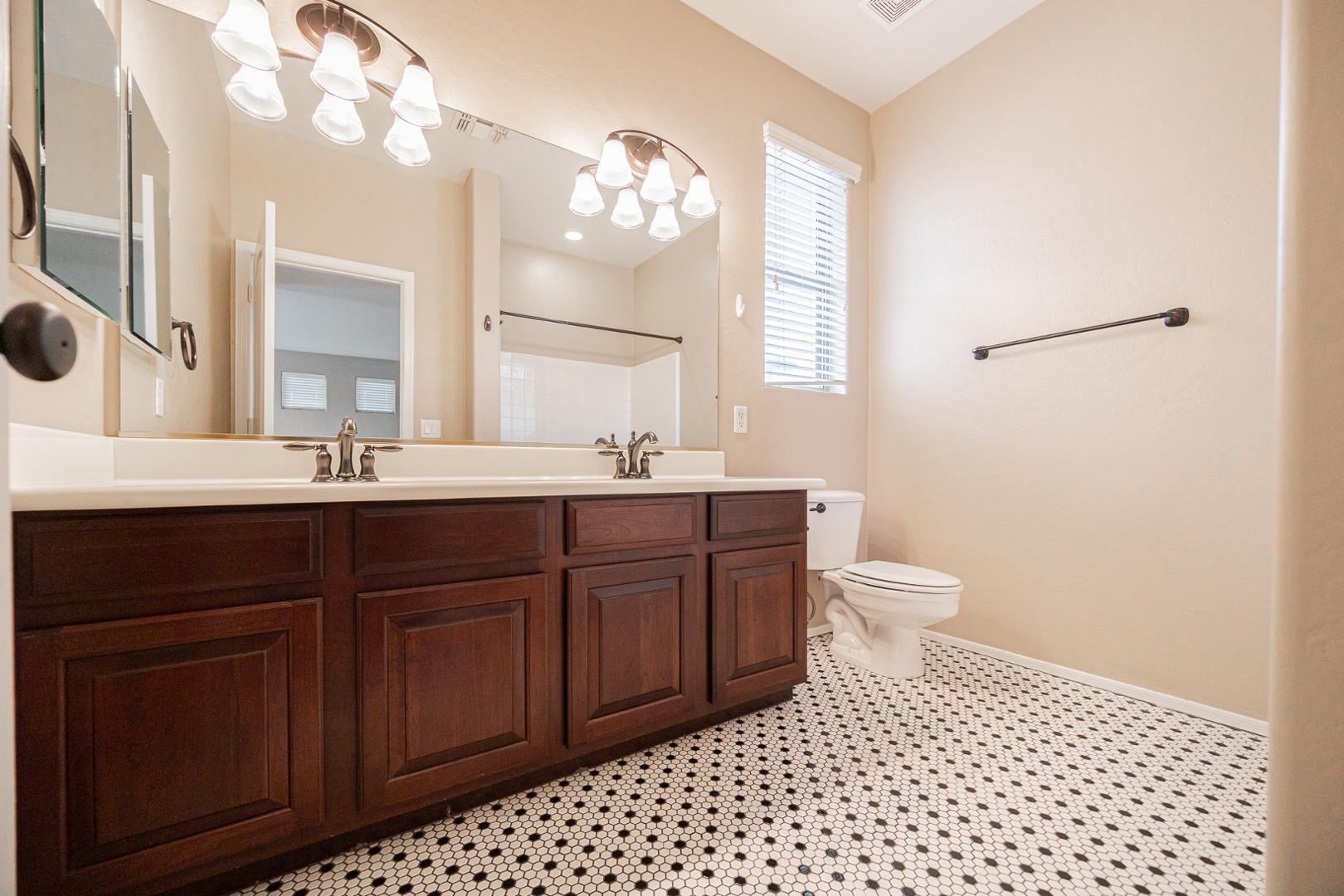 6539 West Jomax Road Phoenix, AZ 85083 - Photo 26 of 39 a bathroom with a sink a toilet a mirror a vanity and shower