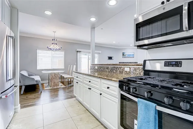 a kitchen with stainless steel appliances granite countertop a stove and a microwave