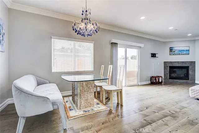 a view of a livingroom with furniture a fireplace and windows