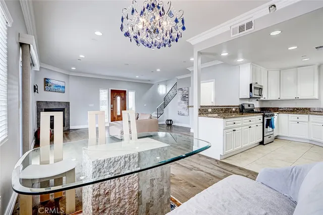 a large kitchen with kitchen island a large counter top stainless steel appliances and cabinets