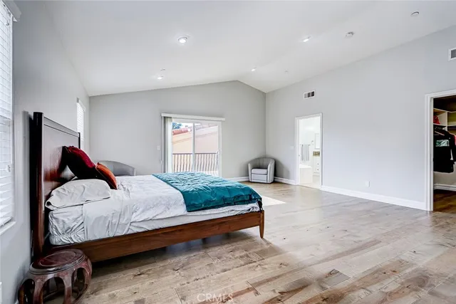 a bedroom with a large bed and a window