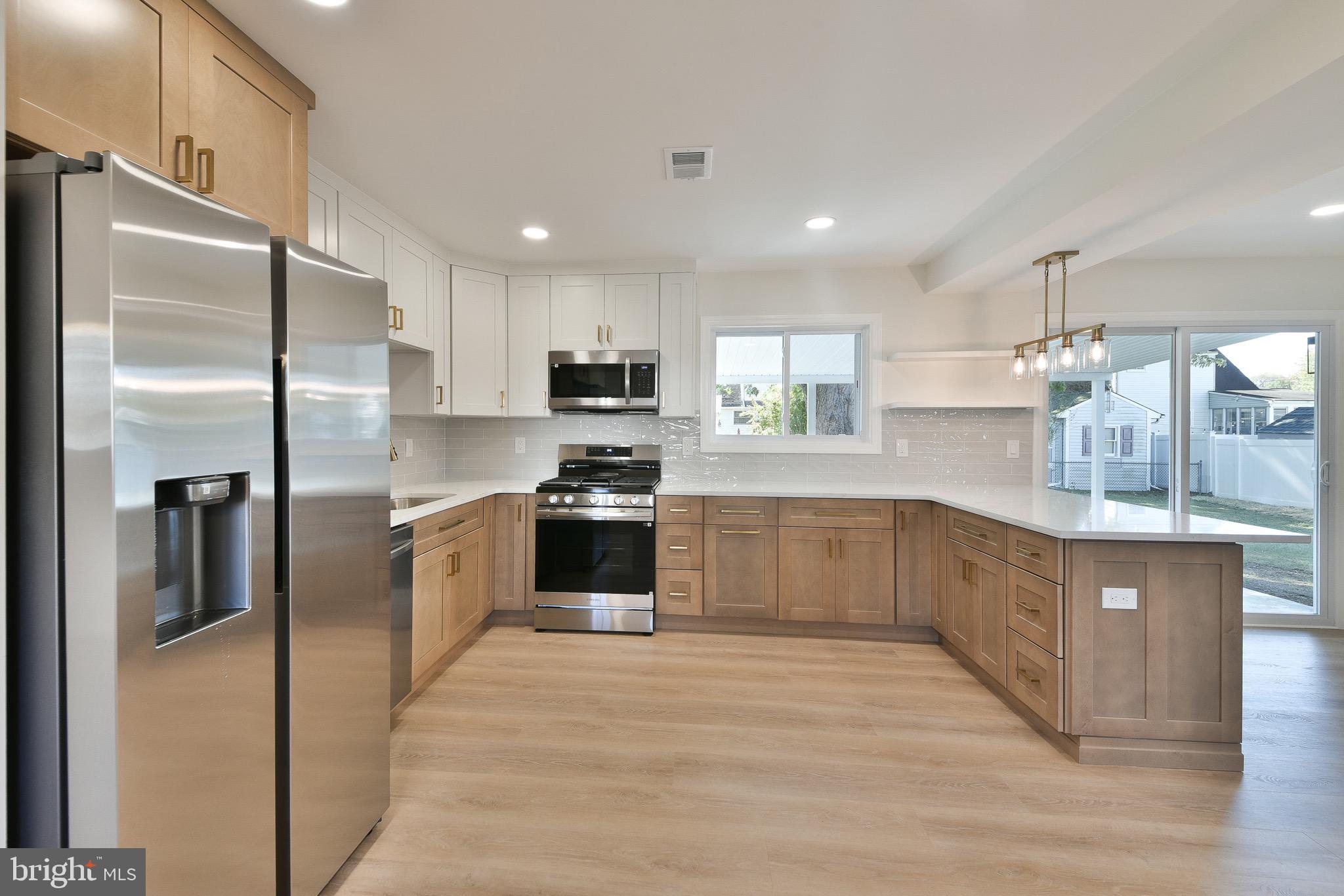 13 Sycamore Way Hamilton, NJ 08690 - Photo 13 of 37 a large kitchen with a refrigerator and a sink