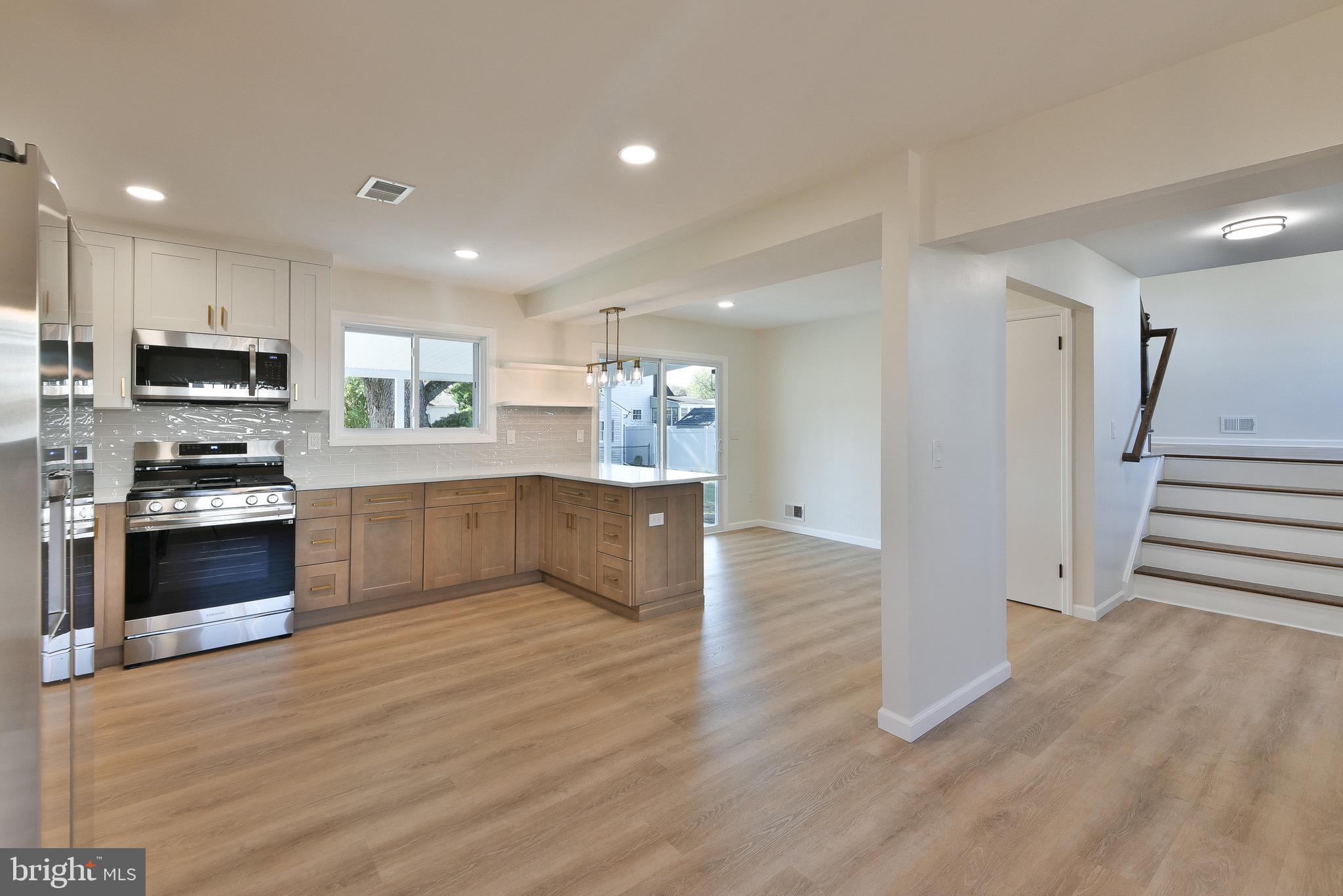 13 Sycamore Way Hamilton, NJ 08690 - Photo 14 of 37 a large kitchen with a stove a sink and a refrigerator