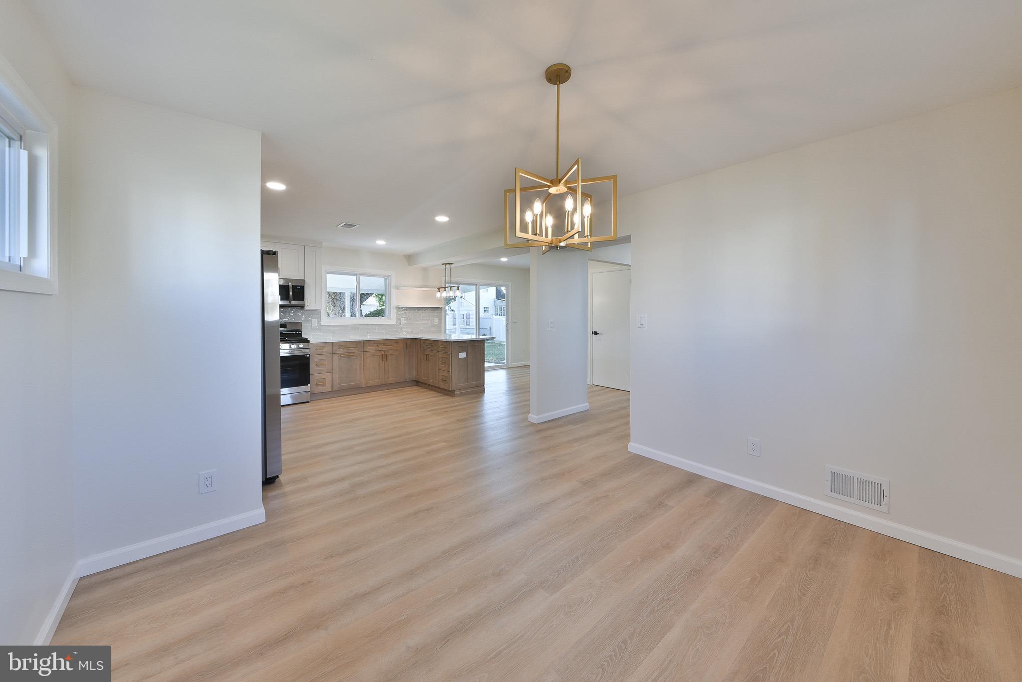 13 Sycamore Way Hamilton, NJ 08690 - Photo 17 of 37 a view of a room with a wooden floor and chandelier