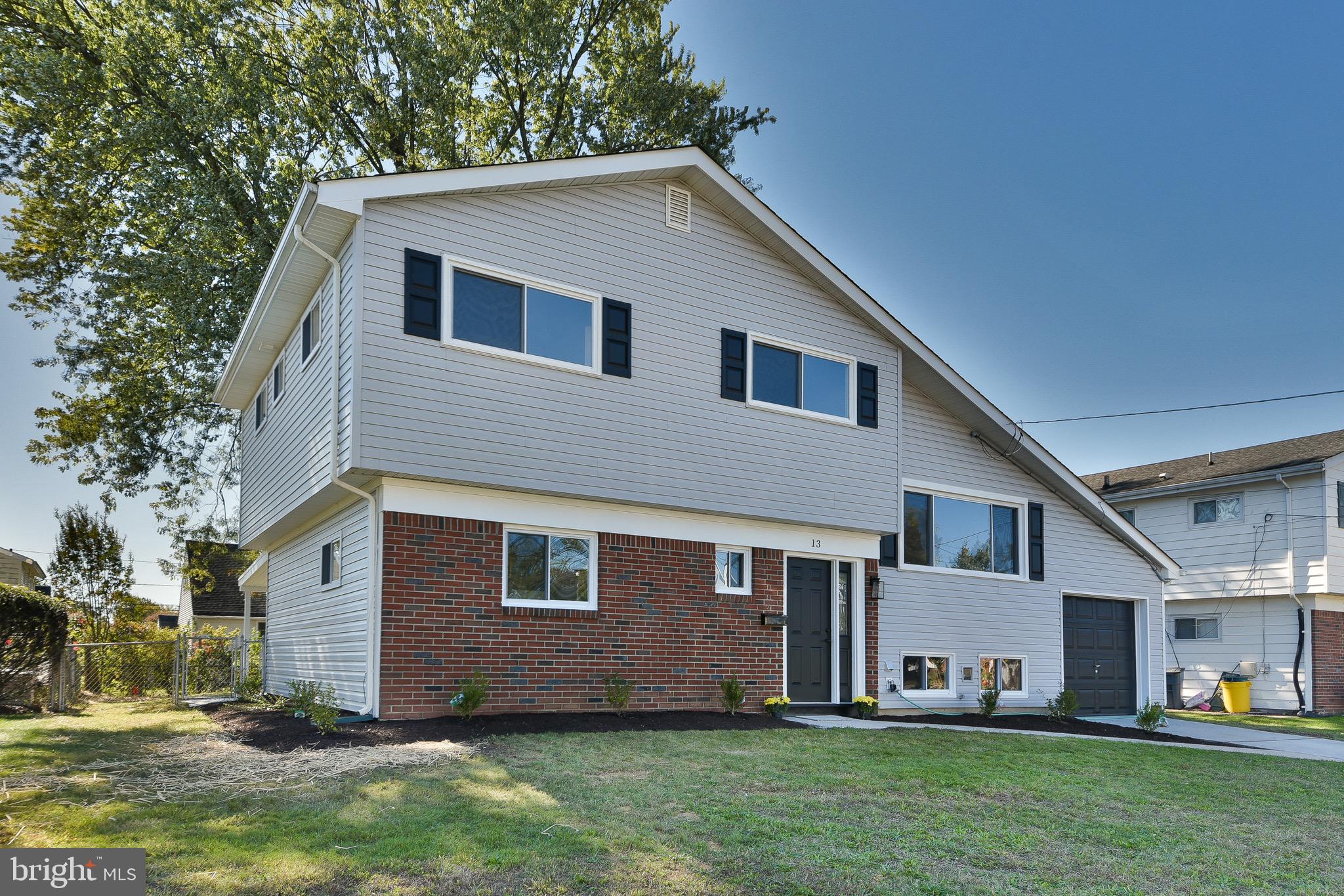 13 Sycamore Way Hamilton, NJ 08690 - Photo 2 of 37 a front view of a house with a yard