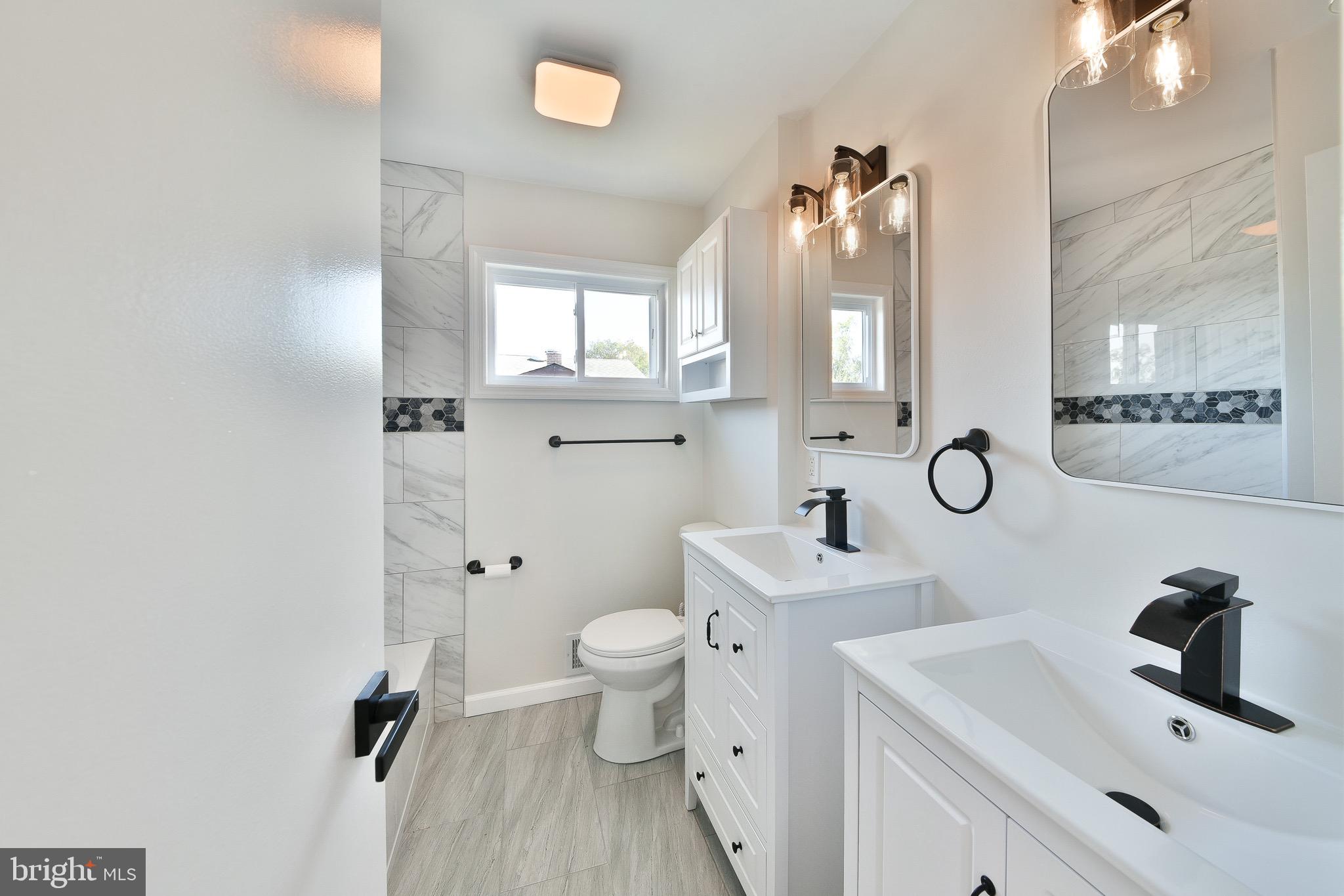 13 Sycamore Way Hamilton, NJ 08690 - Photo 28 of 37 a bathroom with a sink toilet and mirror