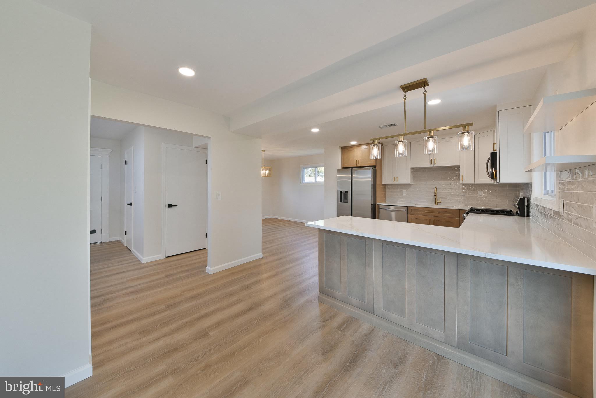 13 Sycamore Way Hamilton, NJ 08690 - Photo 10 of 37 a view of kitchen with kitchen island white cabinets and wooden floor