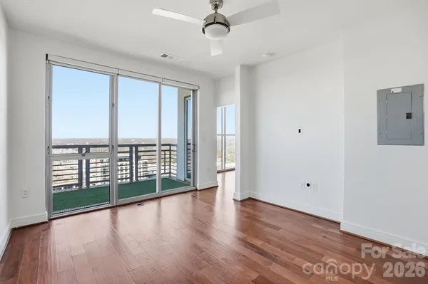 a view of an empty room with wooden floor