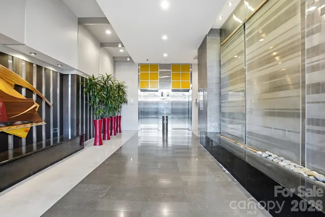 a kitchen with stainless steel appliances granite countertop a sink a stove a refrigerator and island