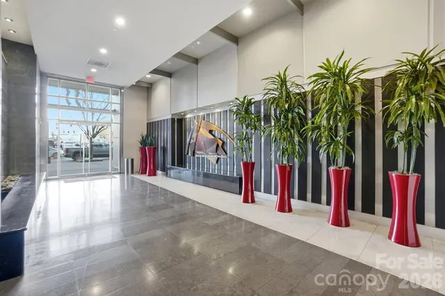 a kitchen with stainless steel appliances granite countertop a sink and a refrigerator