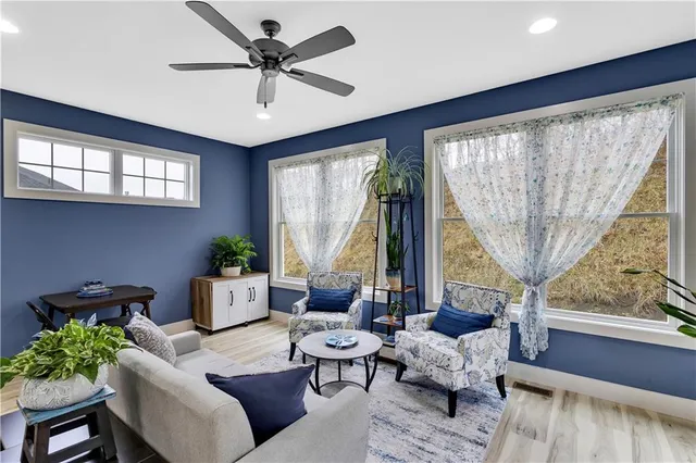 a living room with furniture and a large window