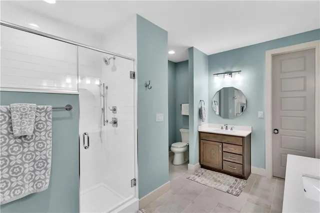 a bathroom with a double vanity sink mirror and shower