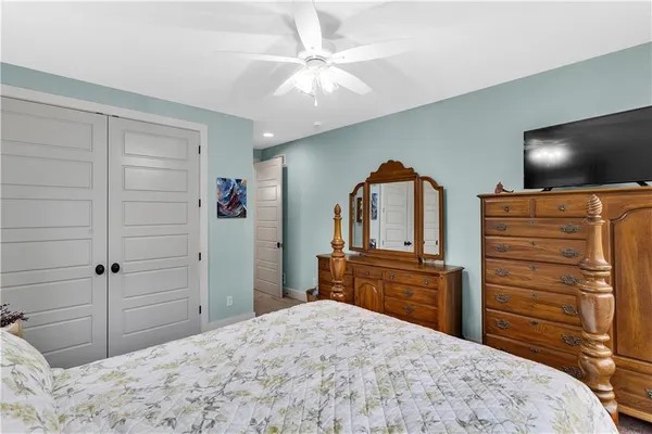 a bedroom with a bed and a dresser