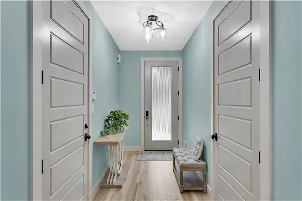 a view of a hallway to a livingroom with furniture