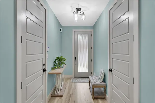 a view of a hallway to a livingroom with furniture