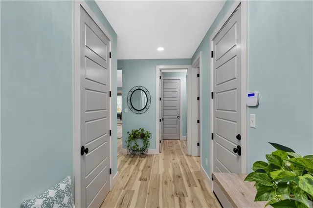 a view of a hallway with wooden floor and glass door