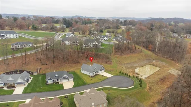 an aerial view of a house with yard swimming pool and mountain view