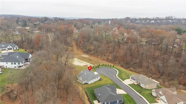 an aerial view of a house with yard swimming pool and mountain view