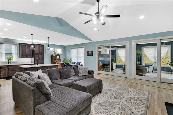 a living room with furniture and a chandelier