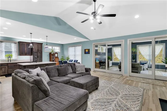 a living room with furniture and a chandelier