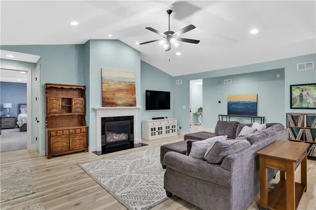 a living room with furniture a fireplace and a flat screen tv