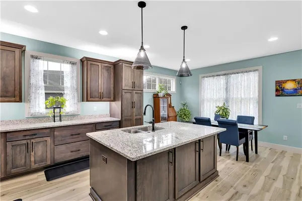 a kitchen with center island table and chairs