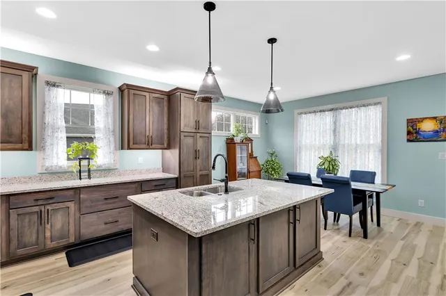 a kitchen with center island table and chairs