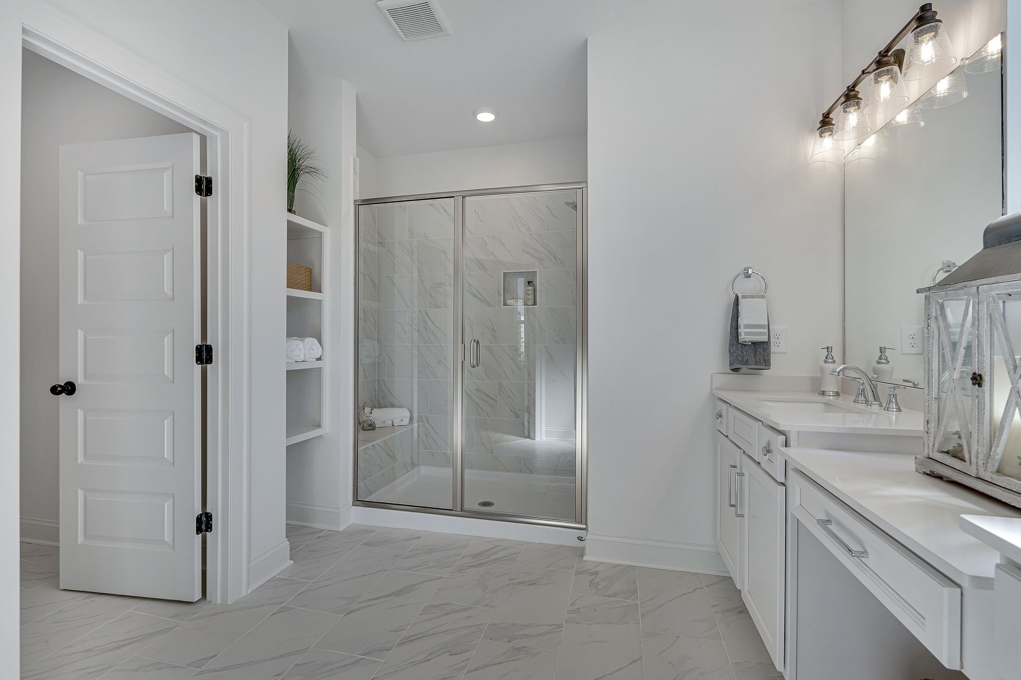 6826 Chatsworth Court Murfreesboro, TN 37129 - Photo 24 of 32 a bathroom with a double vanity sink a large mirror and a shower