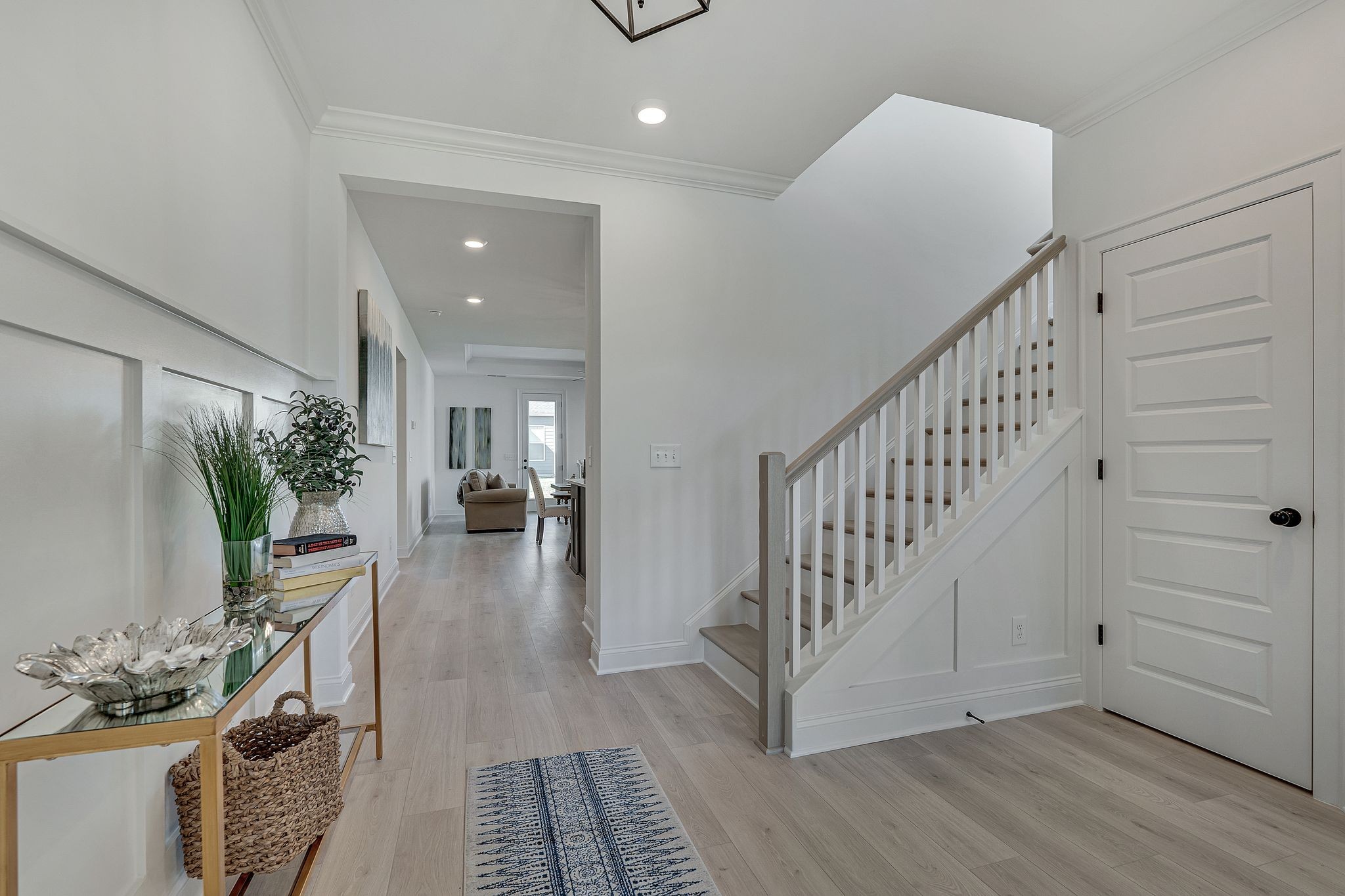 6826 Chatsworth Court Murfreesboro, TN 37129 - Photo 4 of 32 a view of a hallway to a livingroom with furniture stairs wooden floor and windows