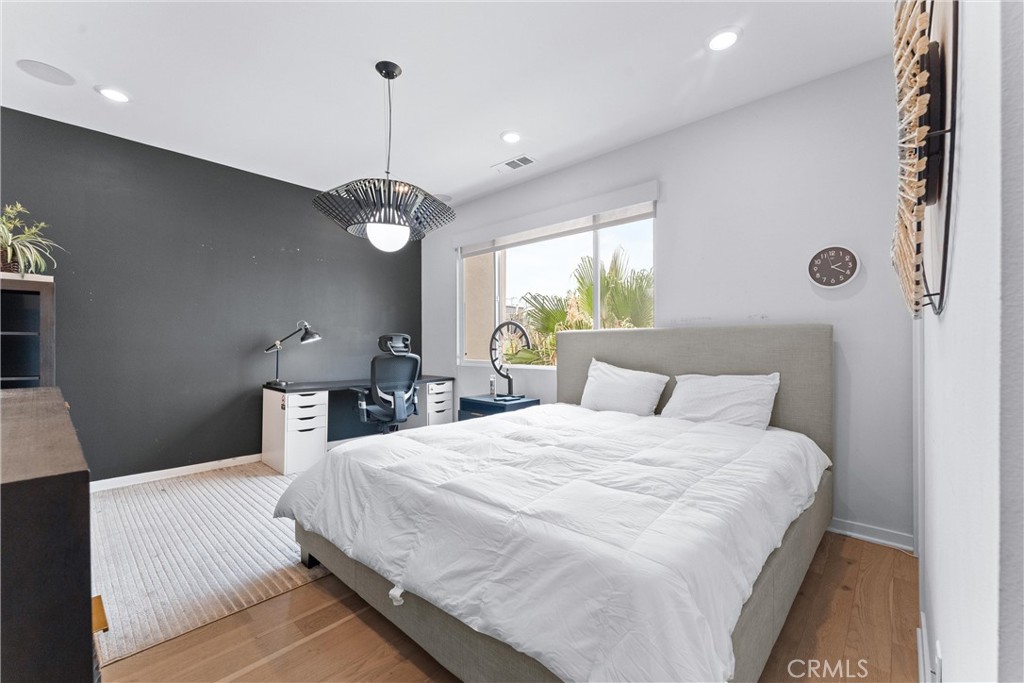 134 Citysquare Irvine, CA 92614 - Photo 20 of 32 a bedroom with a bed and a chandelier