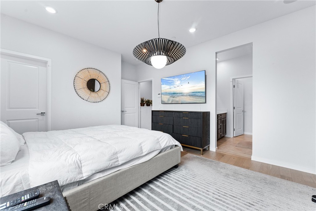 134 Citysquare Irvine, CA 92614 - Photo 21 of 32 a bedroom with a bed and a chandelier