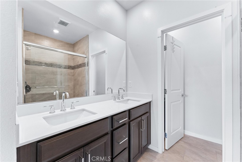 134 Citysquare Irvine, CA 92614 - Photo 23 of 32 a bathroom with a sink double vanity and a mirror