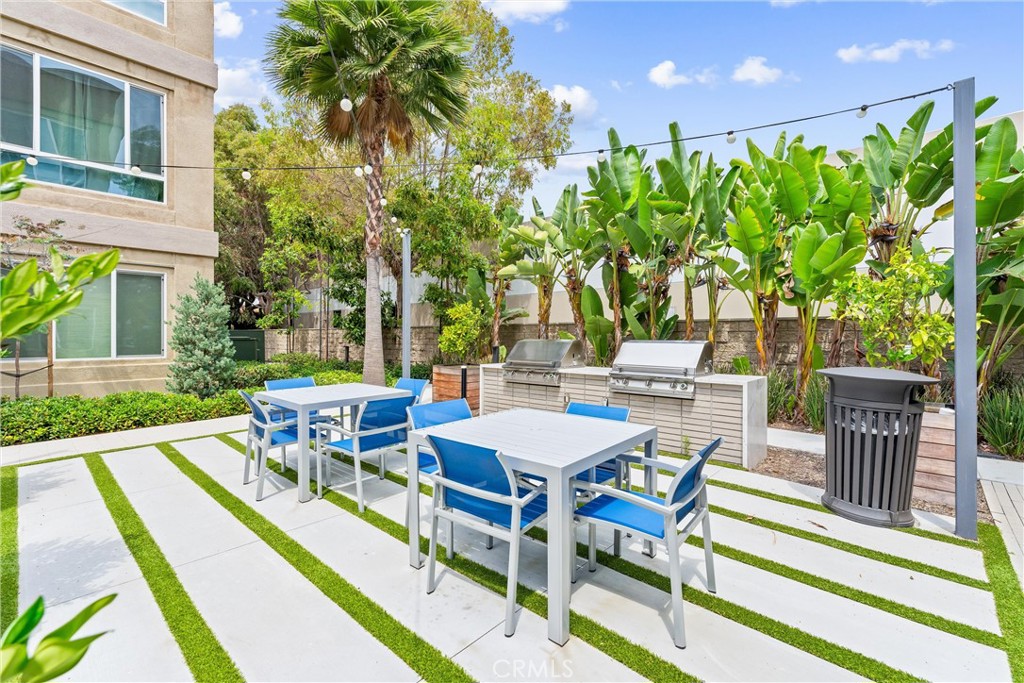 134 Citysquare Irvine, CA 92614 - Photo 30 of 32 a view of a patio with table and chairs and potted plants