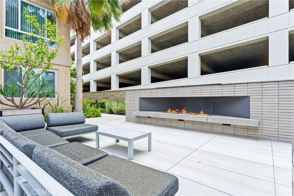 134 Citysquare Irvine, CA 92614 - Photo 32 of 32 a view of a patio with couches and a fireplace