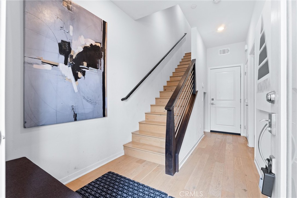 134 Citysquare Irvine, CA 92614 - Photo 4 of 32 a view of entryway and hall with wooden floor