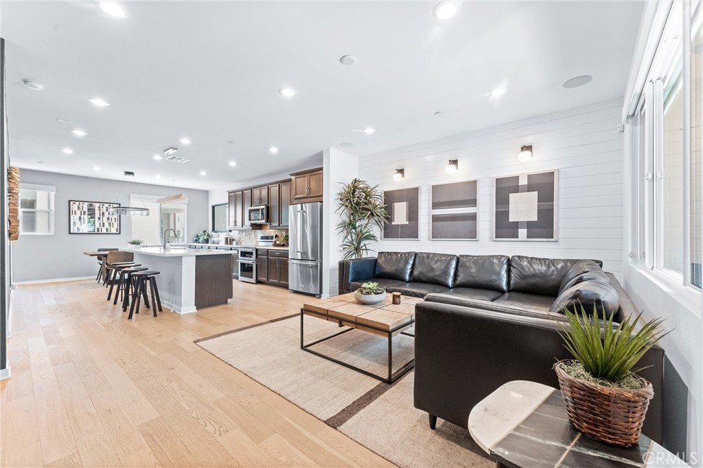 134 Citysquare Irvine, CA 92614 - Photo 8 of 32 a living room with furniture potted plant and kitchen view