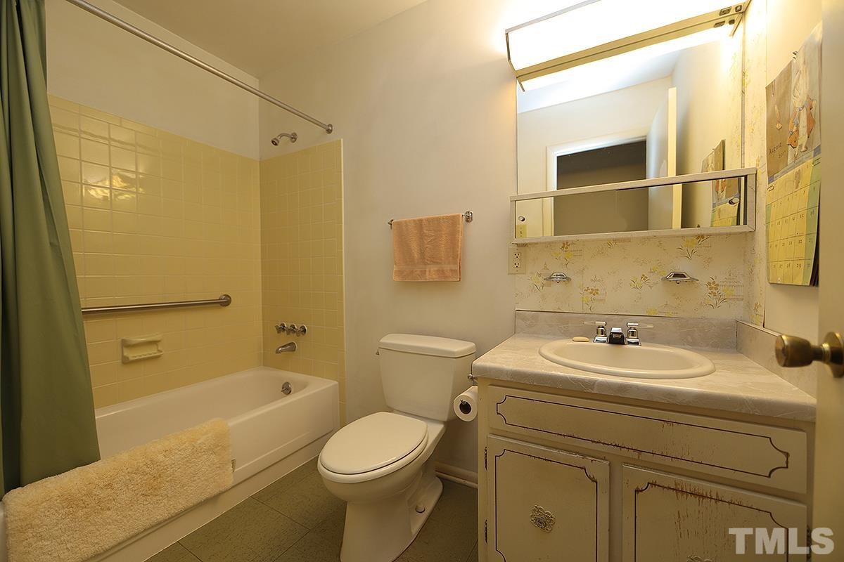 1337 Clermont Road Durham, NC 27713 - Photo 13 of 16 a bathroom with a sink a toilet and shower