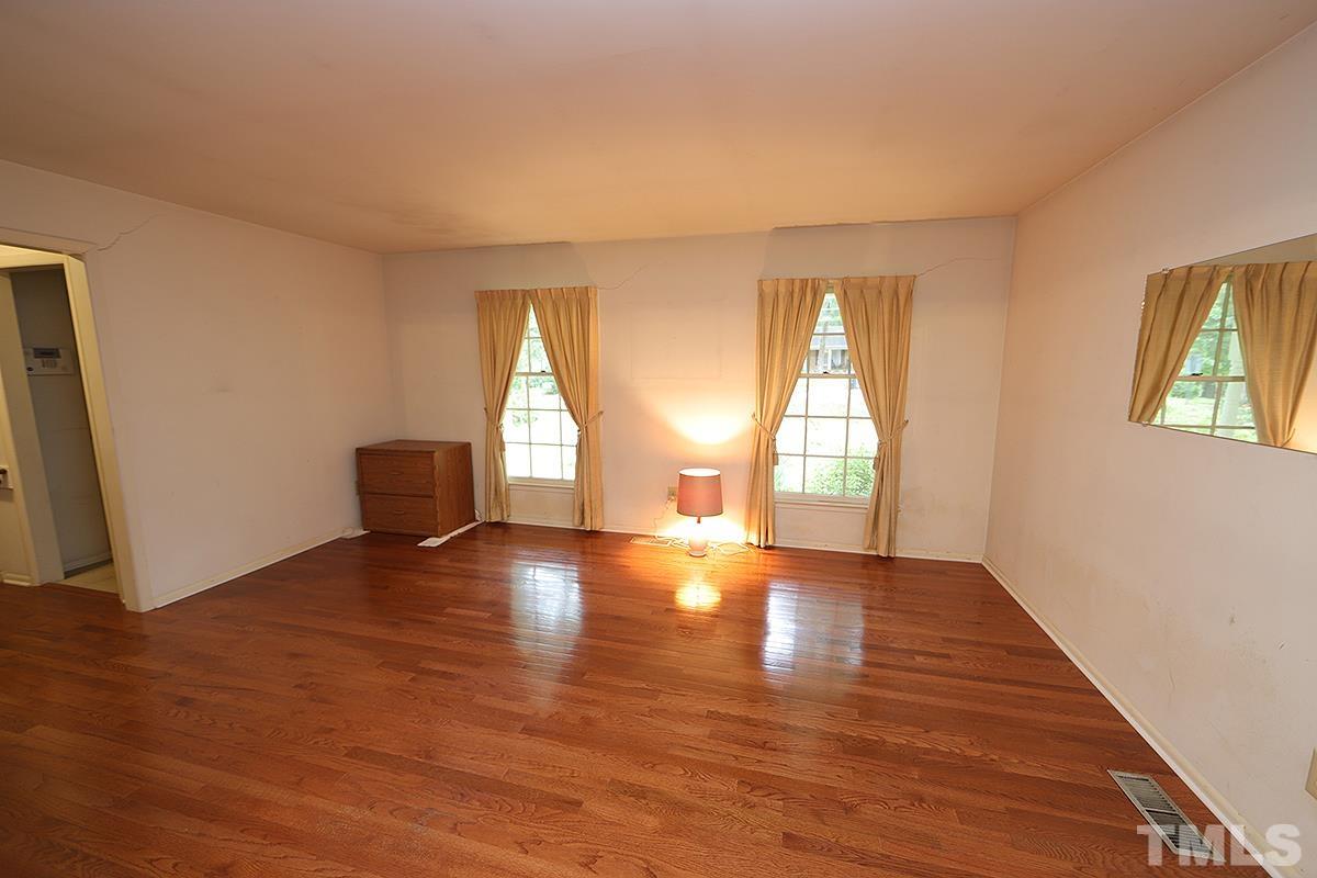 1337 Clermont Road Durham, NC 27713 - Photo 2 of 16 an empty room with wooden floor and windows