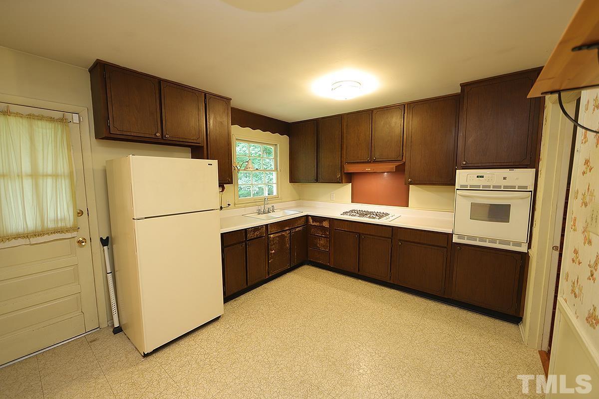 1337 Clermont Road Durham, NC 27713 - Photo 8 of 16 a kitchen with sink a refrigerator and cabinets