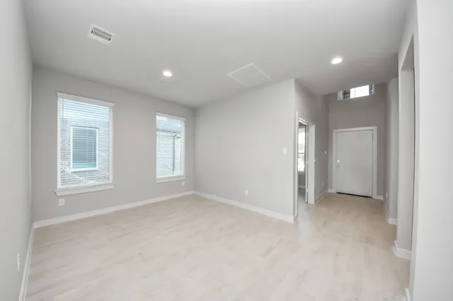 an empty room with windows and entrance