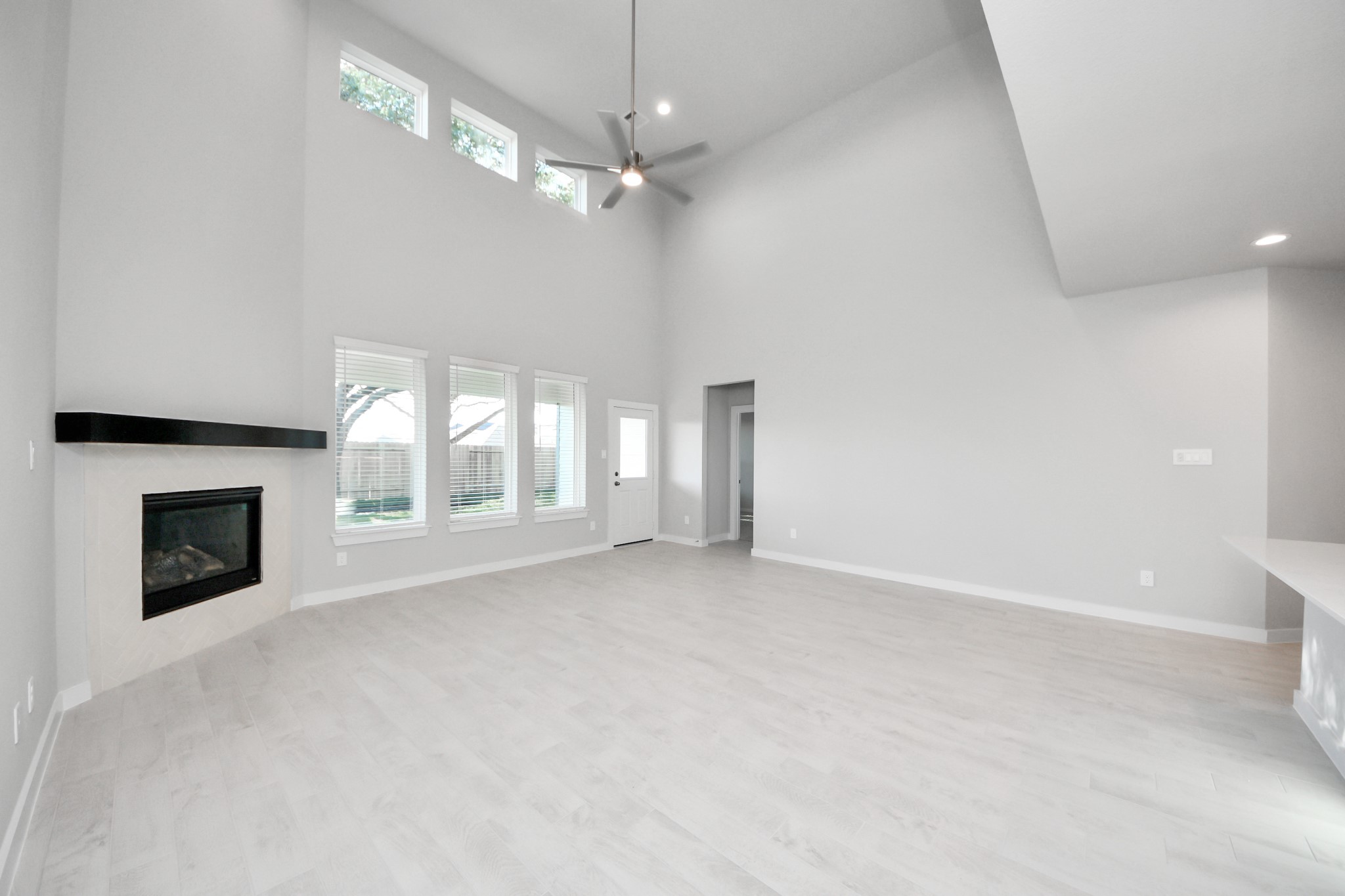 15719 Telge Ridge Lane Cypress, TX 77429 - Photo 22 of 48 an empty room with windows and fireplace