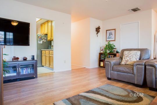 717 Ginger Avenue Ridgecrest, CA 93555 - Photo 5 of 28 a living room with furniture and a flat screen tv